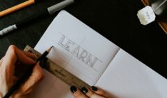 person writing on white paper